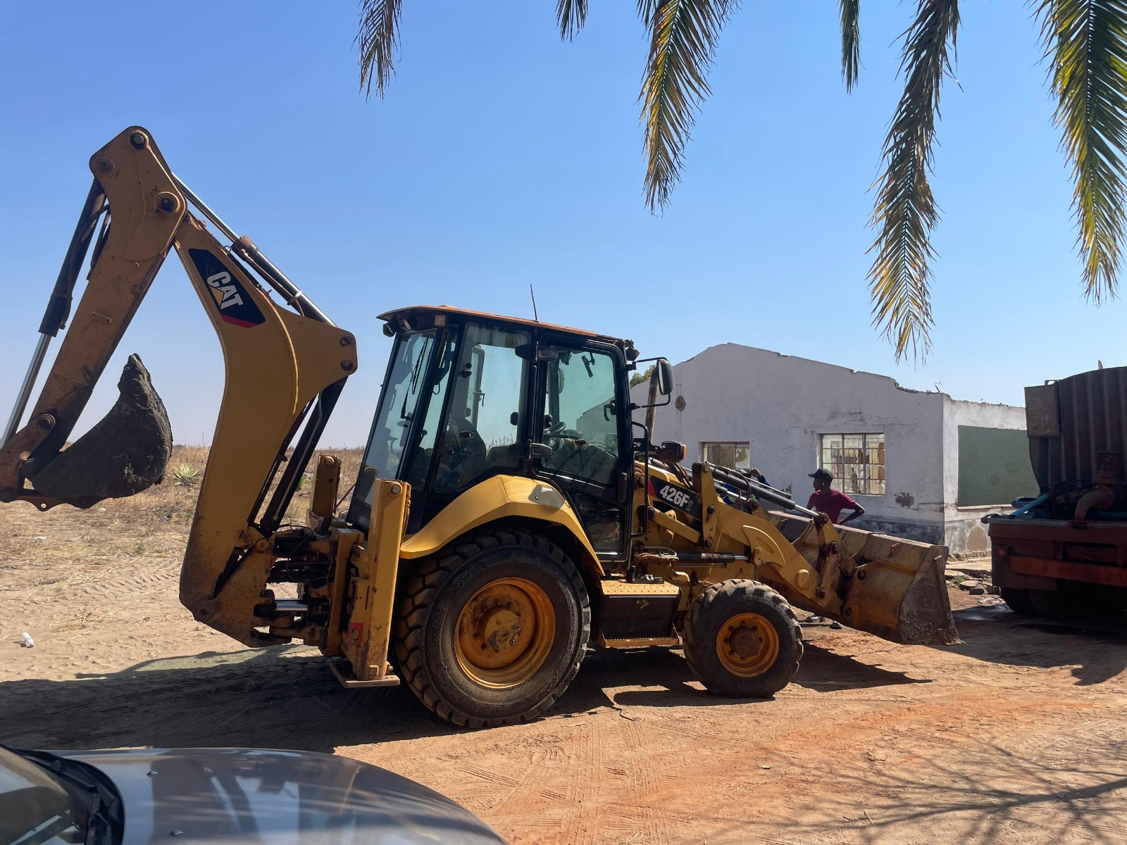 Backhoe and crew on site
